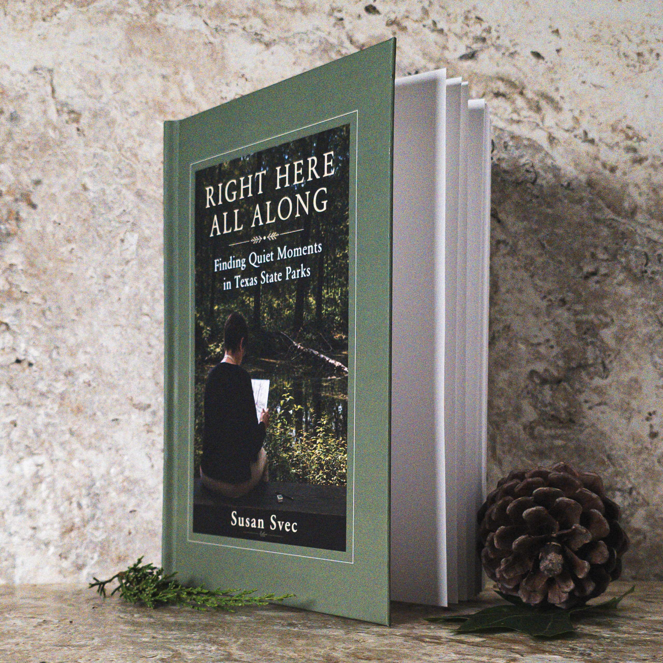 Right Here All Along: Finding Quiet Moments in Texas State Parks — sage green hardcover by Susan Svec, showing Susan sketching beside the water